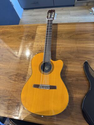 Item 7: amber nylon-string classical guitar with a cutaway