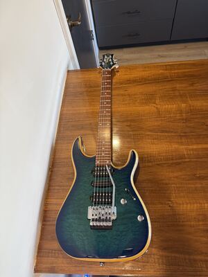 Item 8: blue-green quilted-top Washburn electric guitar